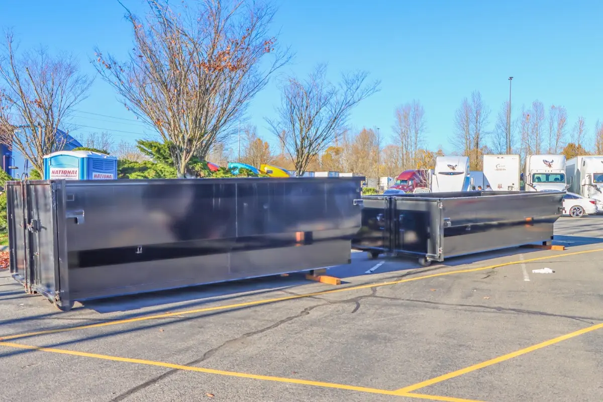 Professional dumpster rental service with roll-off container on residential driveway in Triangle